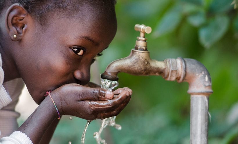 Boy Drinking water from tap